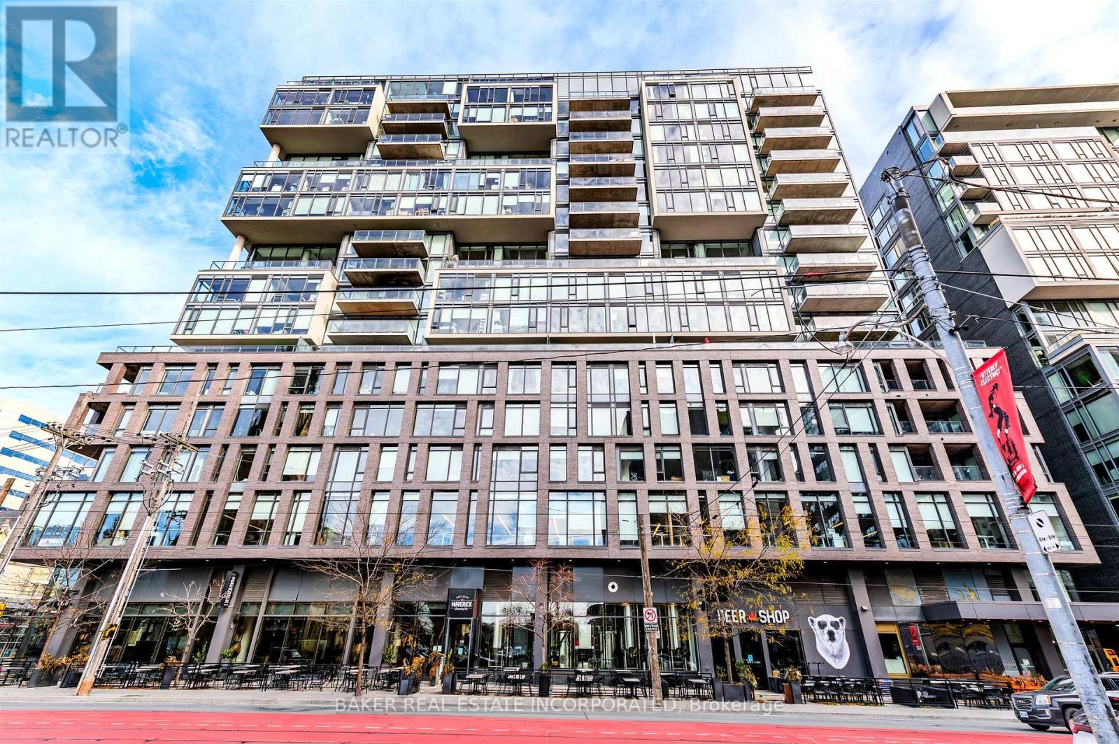 A tall building with a glass facade and a sign that reads "REALTOR".