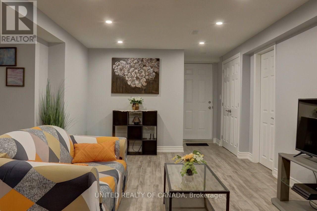A living room with a couch, a coffee table, and a television.