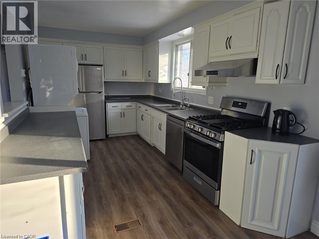 A kitchen with white cabinets and a black stove top.