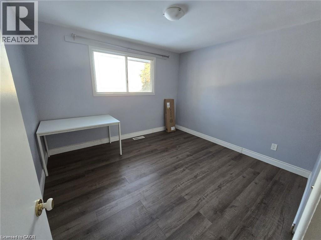 A bedroom with a bed and a window.