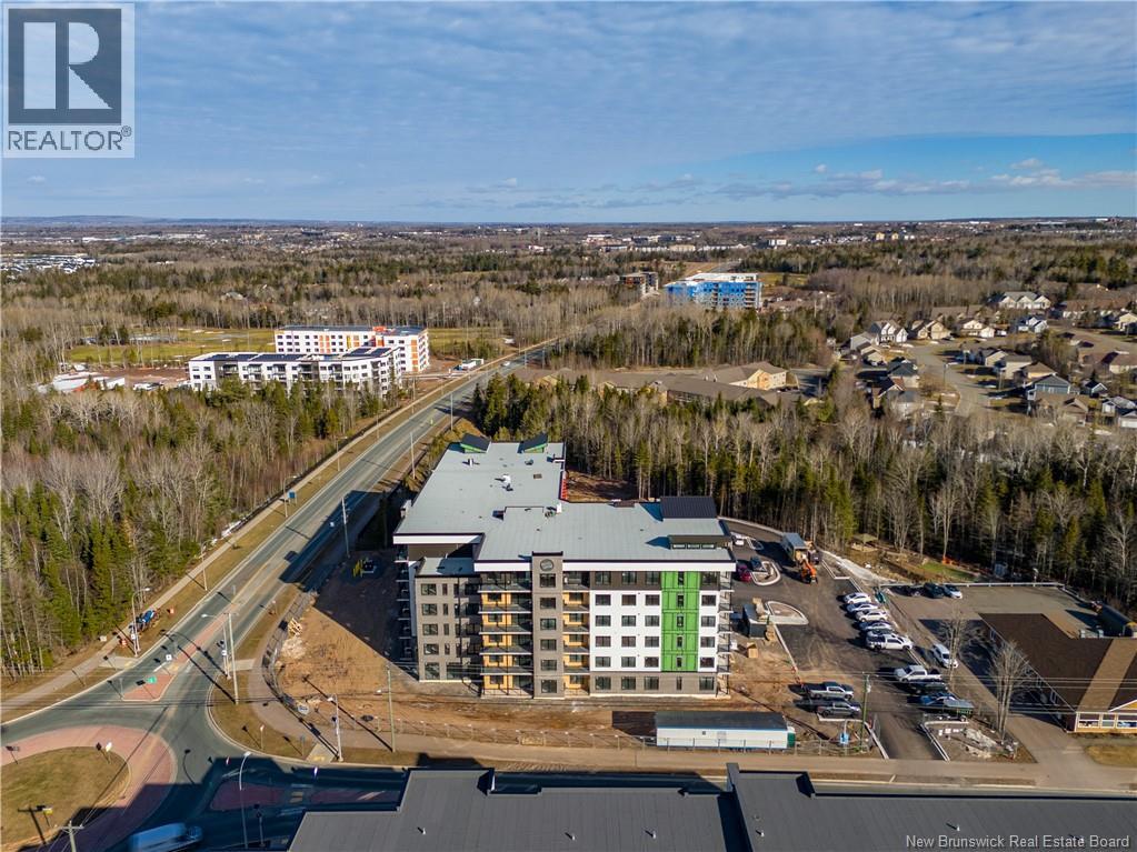 A real estate board logo is visible on an aerial image of a building complex.