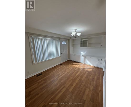 A room with wooden floors and white walls.