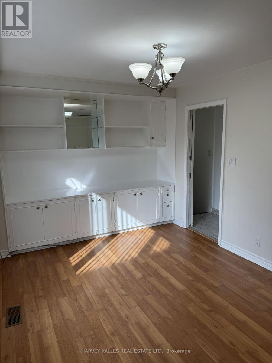A room with wooden floors and white walls.