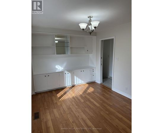 A room with wooden floors and white walls.