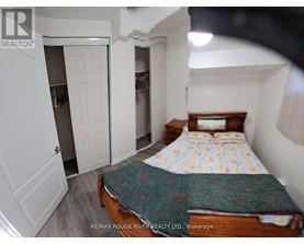 A bedroom with a bed, dresser, and closet.