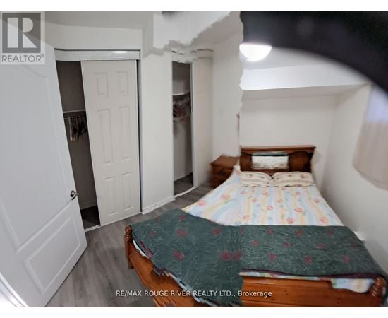 A bedroom with a bed, dresser, and closet.