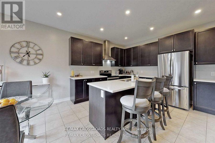 A modern kitchen with a glass table and bar stools.