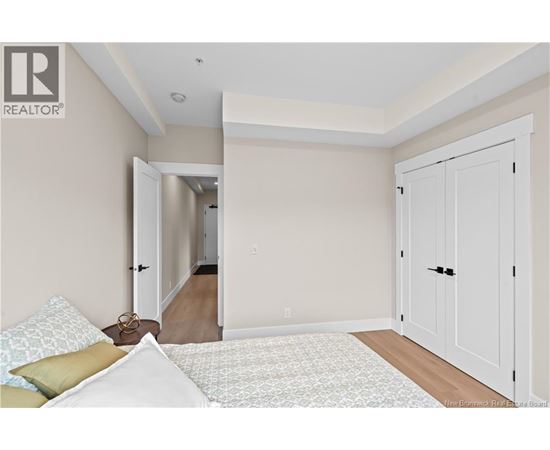 A bedroom with a bed and a wardrobe.