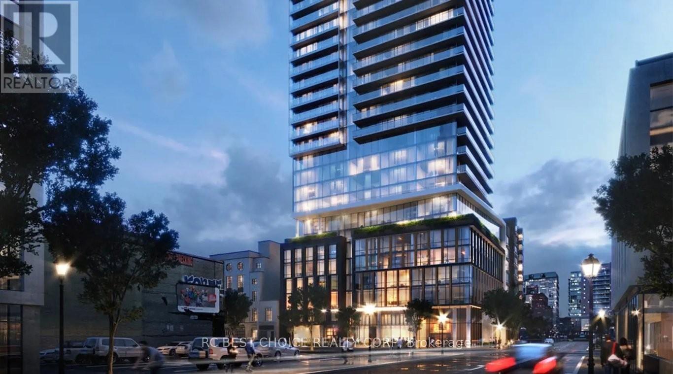 A modern building with a glass facade stands tall in the city.