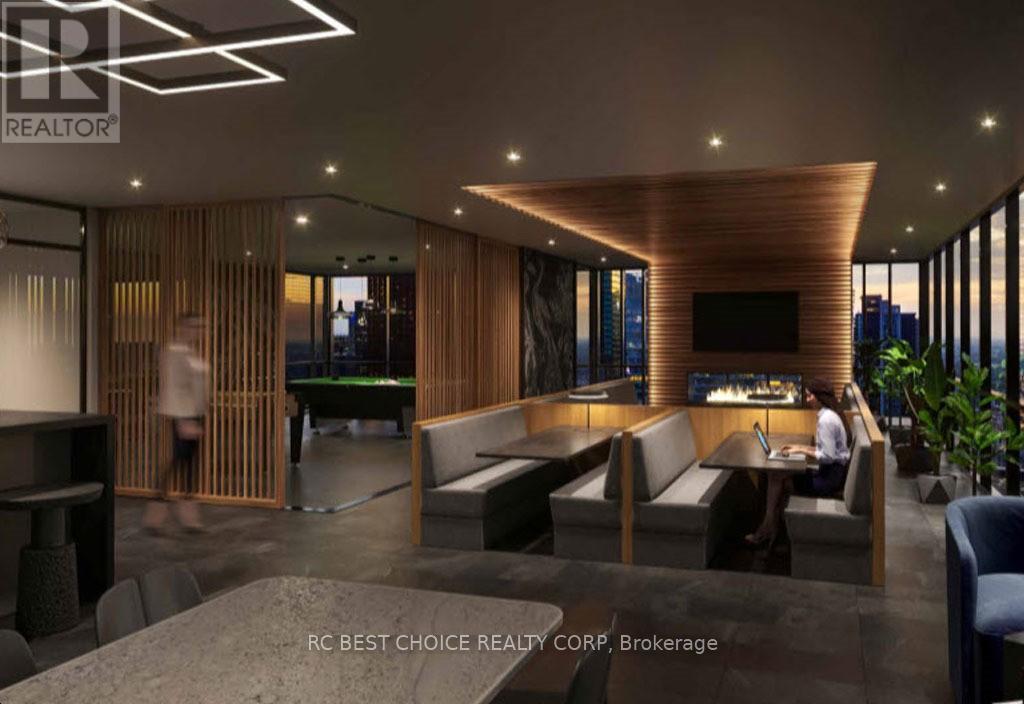 A modern interior space with a pool table and a person playing pool.