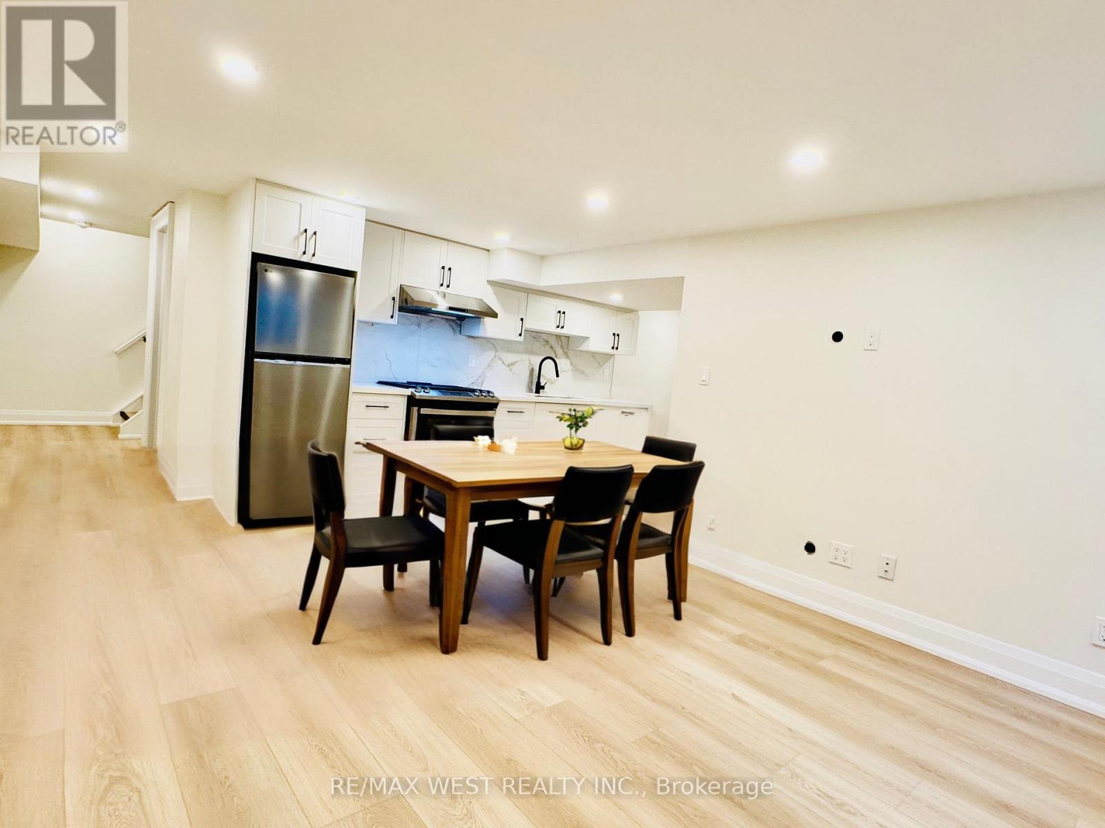 A dining room with a wooden table and chairs.