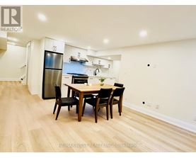 A dining room with a wooden table and chairs.