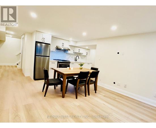 A dining room with a wooden table and chairs.