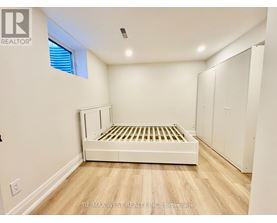 A bedroom with a bed, wardrobe and window.
