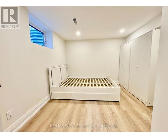 A bedroom with a bed, wardrobe and window.