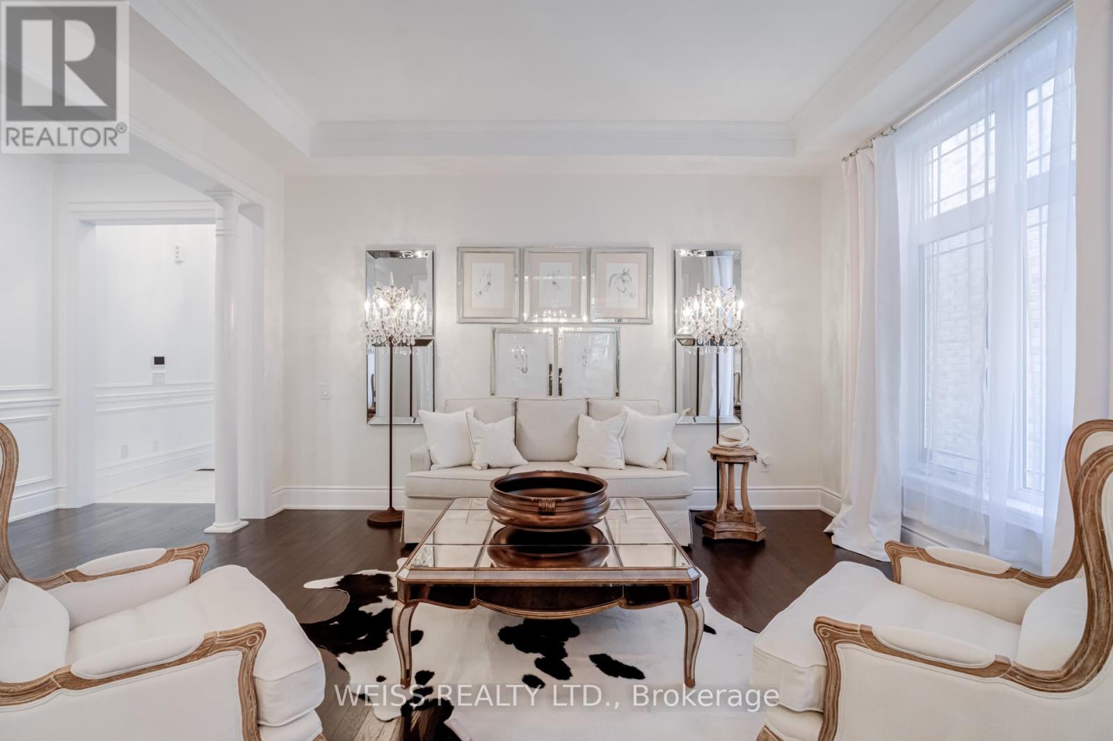 A living room with a white couch and a coffee table.