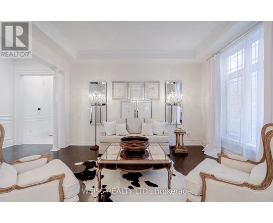 A living room with a white couch and a coffee table.