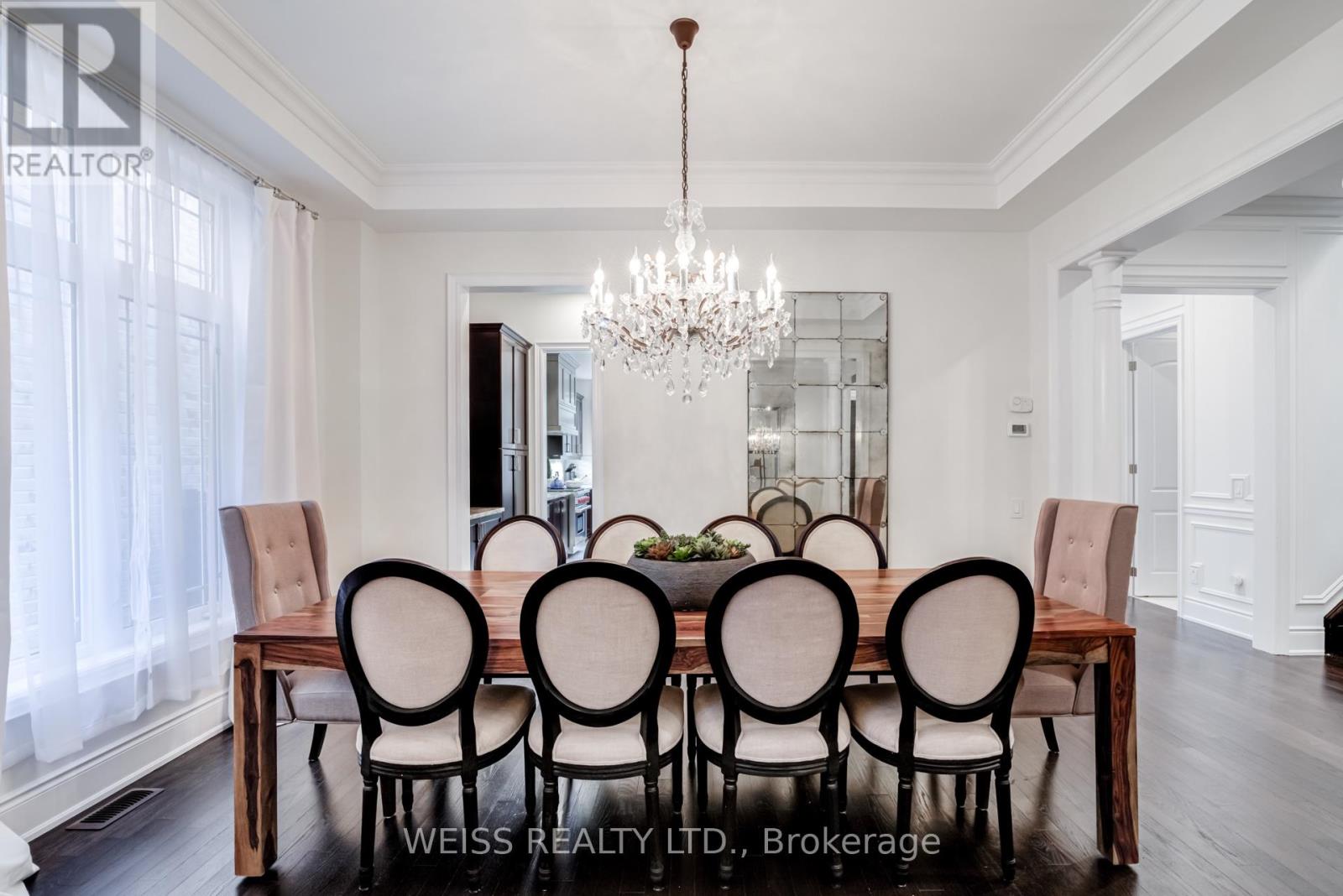 A dining room with a wooden table and chairs.