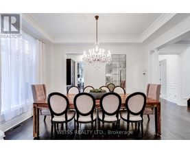 A dining room with a wooden table and chairs.