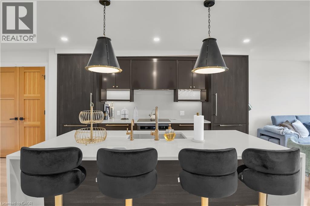A modern kitchen with a dining table and chairs.