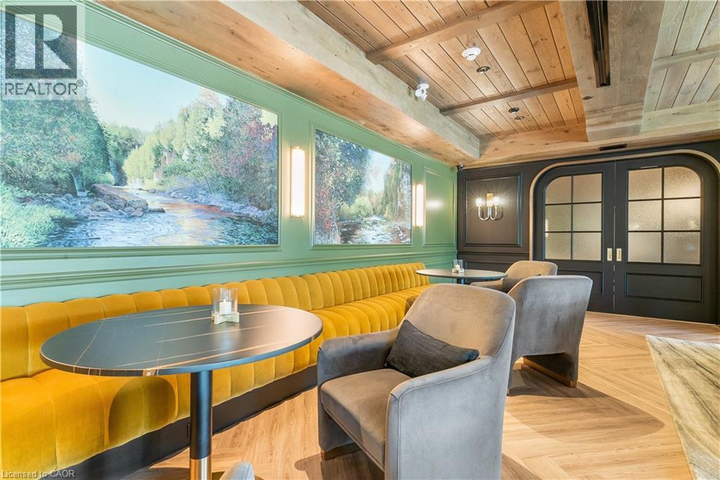 A living room with a table and chairs.
