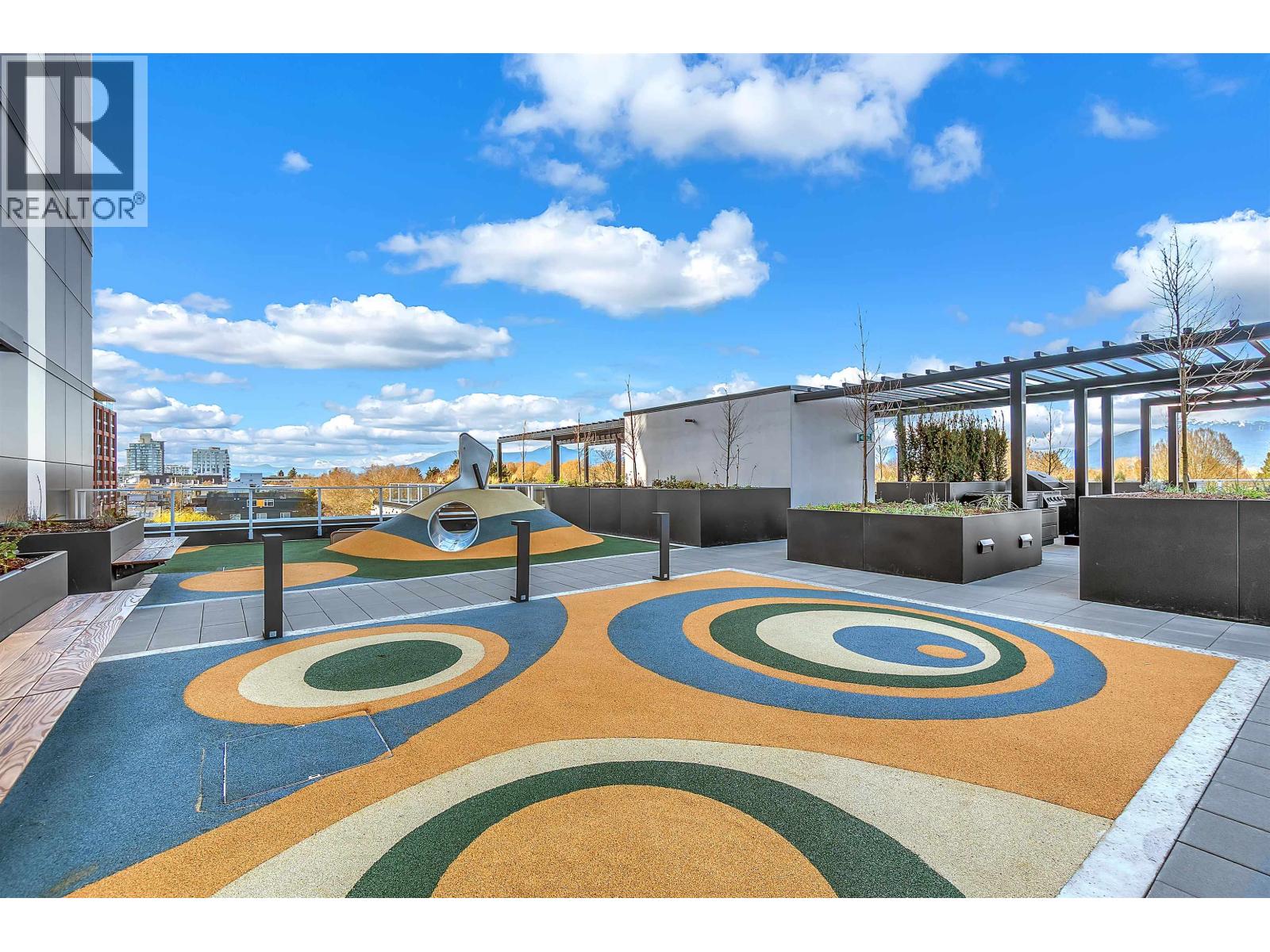 A playground with a blue sky and clouds in the background.
