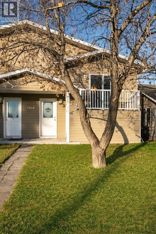 A house with a tree in front of it.