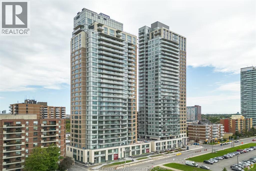 A tall building with many windows is the main focus of this image.