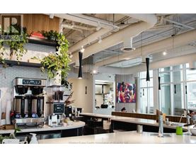 A modern cafe with a counter and a coffee machine.