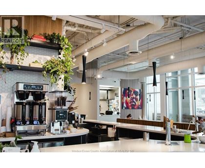 A modern cafe with a counter and a coffee machine.