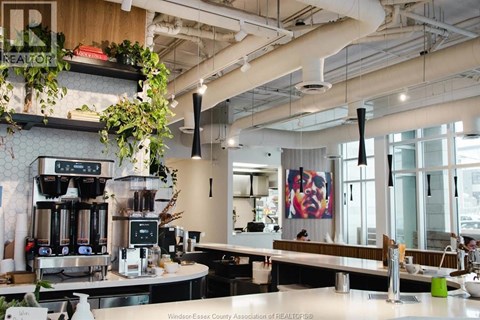 A modern cafe with a counter and a coffee machine.