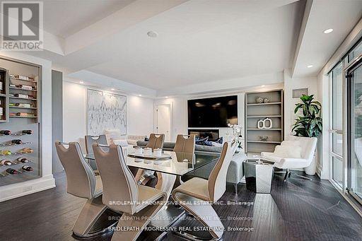 A modern dining room with a glass table and chairs.