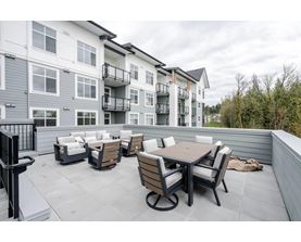 A patio with a table and chairs is in front of a building.
