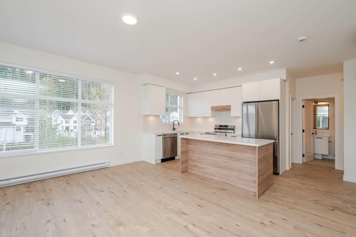 A kitchen with a wooden counter and stainless steel appliances.