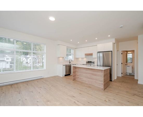 A kitchen with a wooden counter and stainless steel appliances.