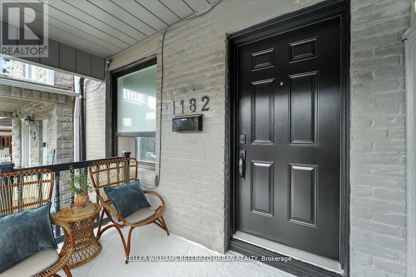 A black door with a glass window is on the right side of the image.