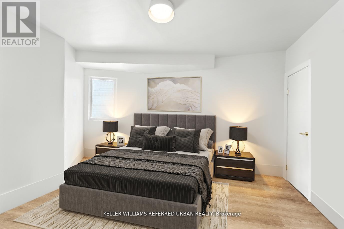 A bedroom with a large bed and two nightstands.