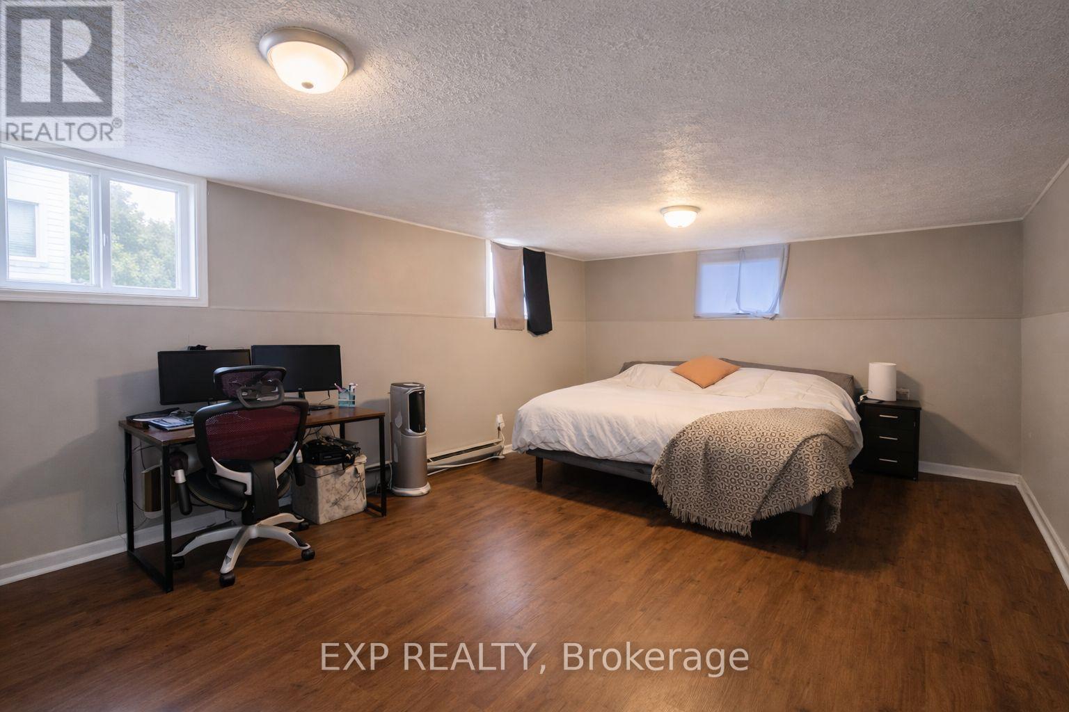 A bedroom with a bed, desk, and chair.