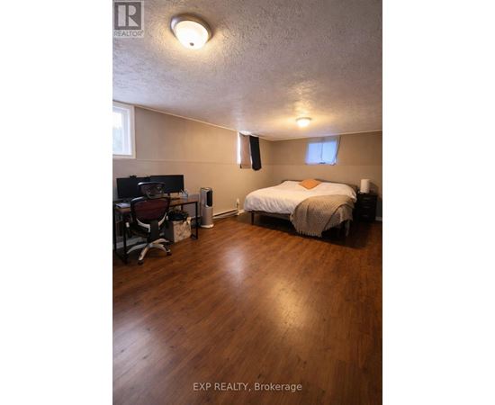 A bedroom with a bed, desk, and chair.