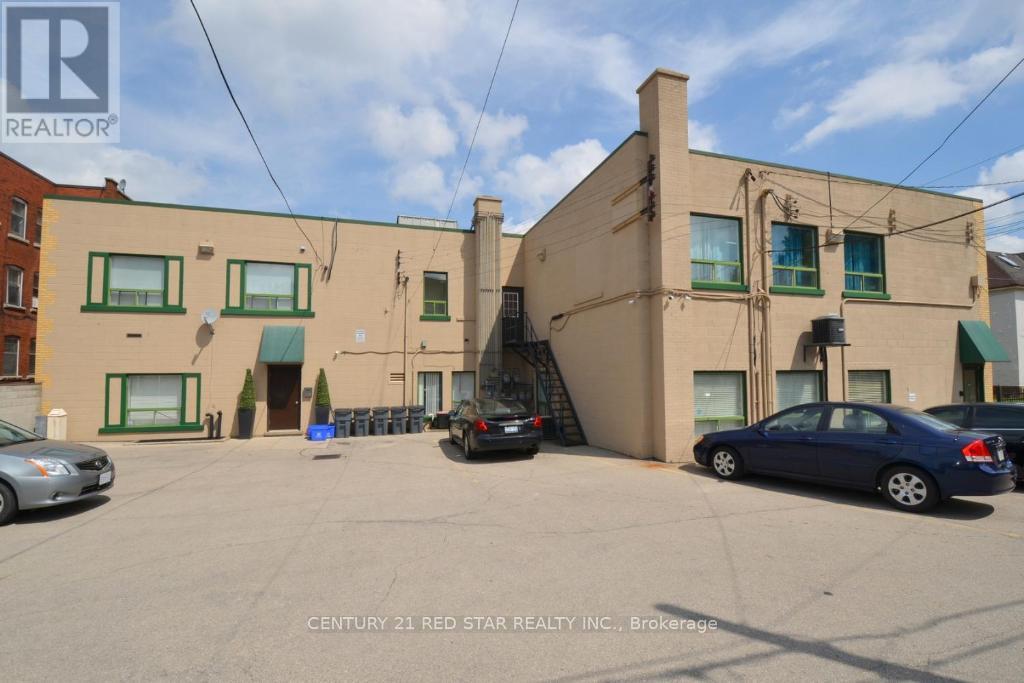 A building with a sign that says Century 21 Red Star Realty Inc., Brokerage.