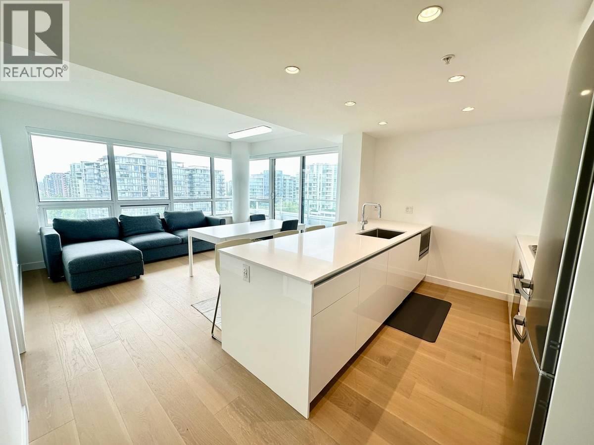 A modern kitchen with white cabinets and a large island.