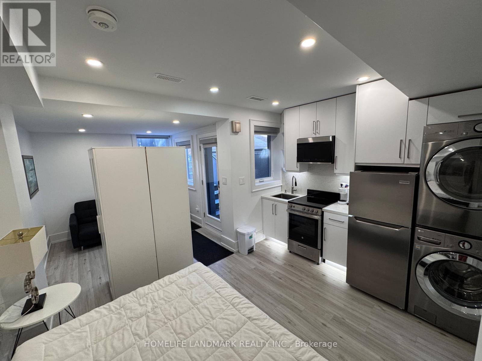 A modern kitchen with stainless steel appliances and white cabinets.