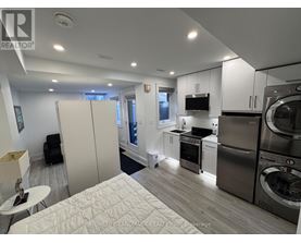 A modern kitchen with stainless steel appliances and white cabinets.