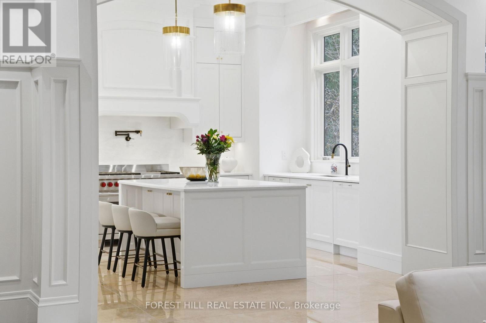 A white kitchen with a table and chairs.