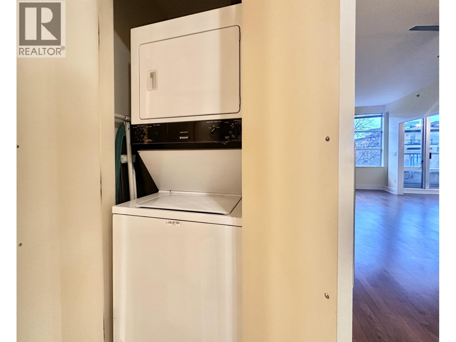 A white dishwasher is built into a kitchen cabinet.