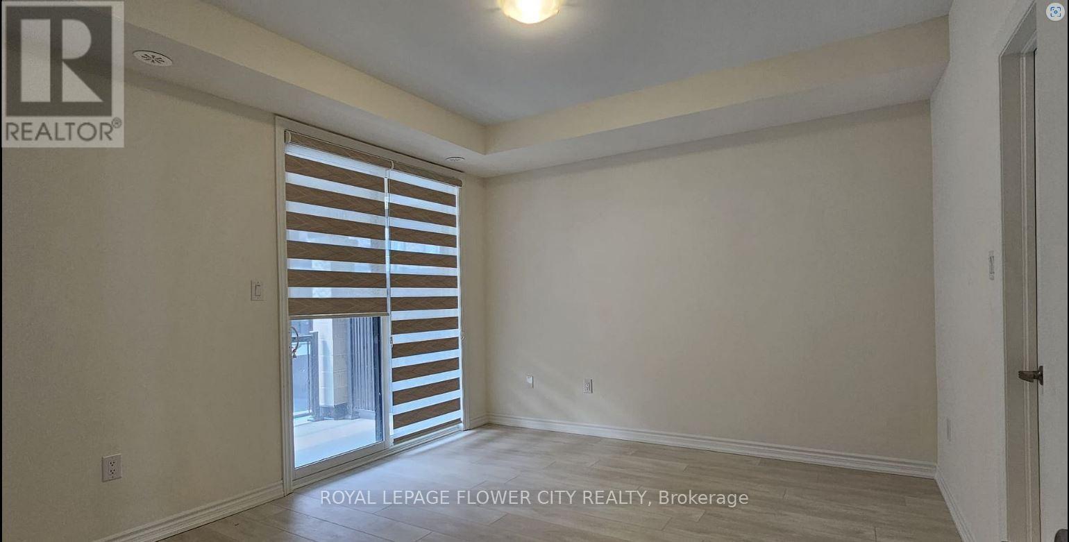 A room with a sliding door and a window with blinds.