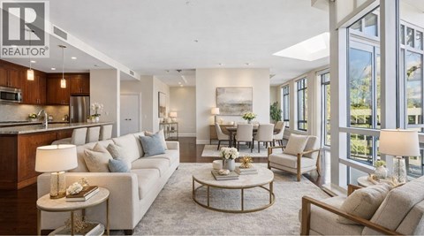 A well-lit, modern living room with a kitchen area in the background.