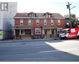 A red brick house with a white truck parked in front.