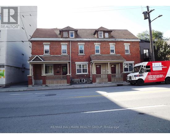 A red brick house with a white truck parked in front.