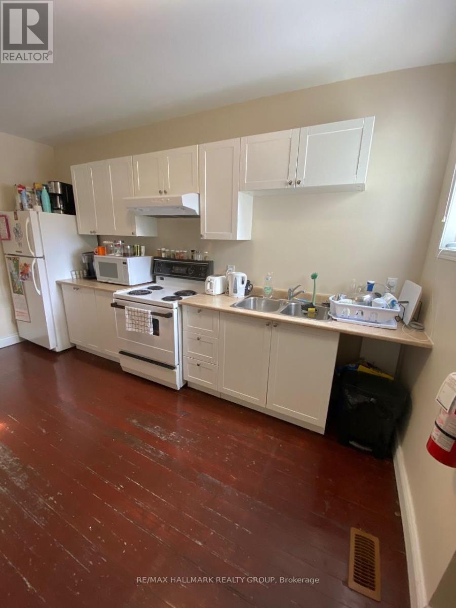 A kitchen with white appliances and cabinets.